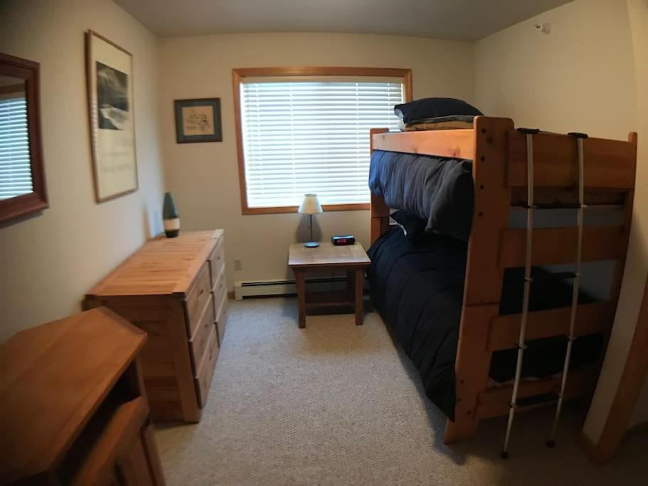 a bedroom with a bunk bed and a desk at Cozy 2 BR Mountain View - walk to resort in Big Sky