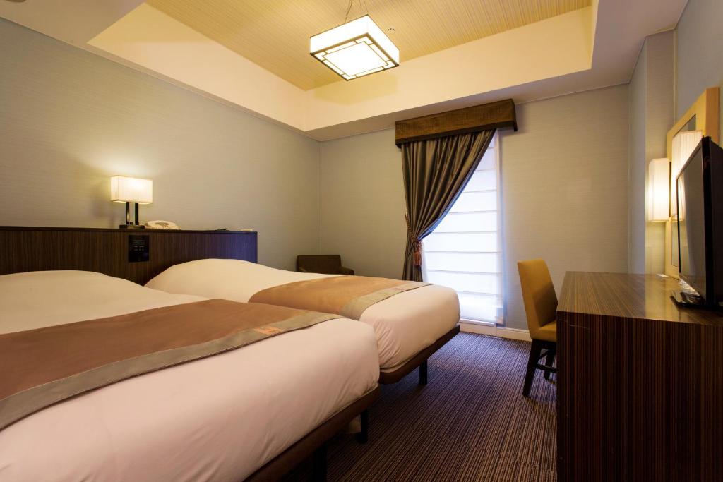 Postel nebo postele na pokoji v ubytování Hotel Monterey Hanzomon