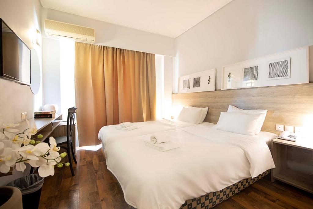 Postel nebo postele na pokoji v ubytování Galaxy Hotel