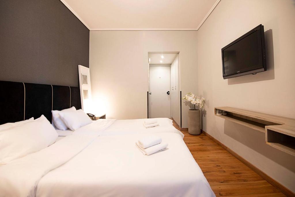Postel nebo postele na pokoji v ubytování Galaxy Hotel
