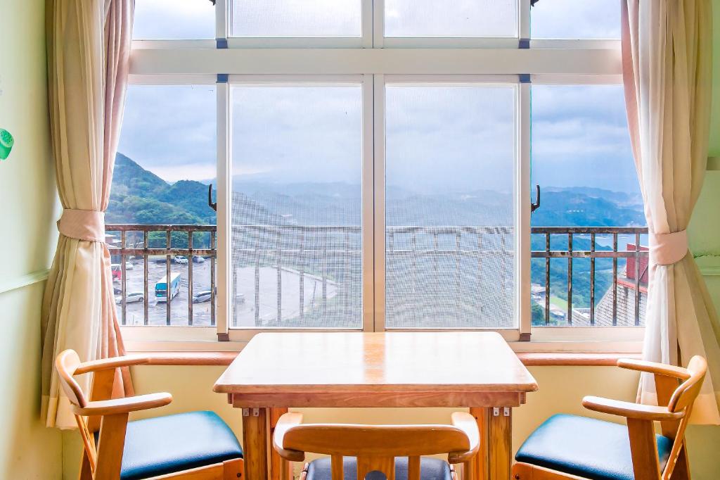 a table and chairs in front of a window at Jiufen Kite Museum in Jiufen