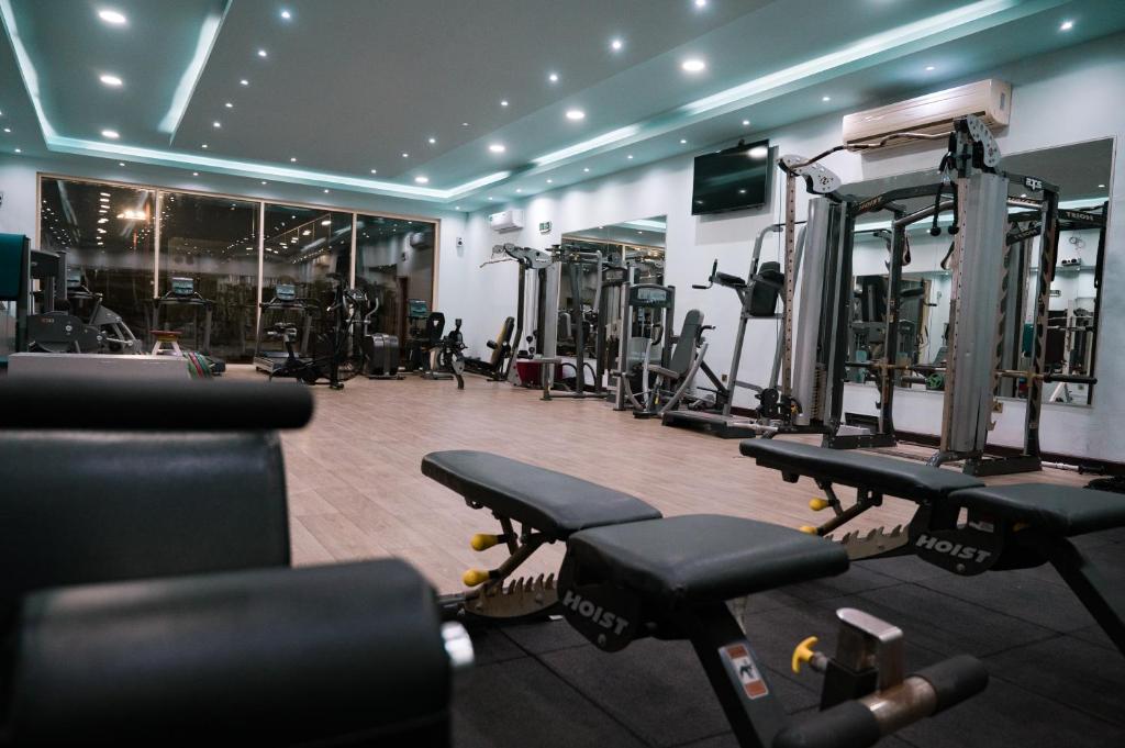 a gym with several rows of treadmills and machines at Ras Al Khaimah Hotel in Ras al Khaimah