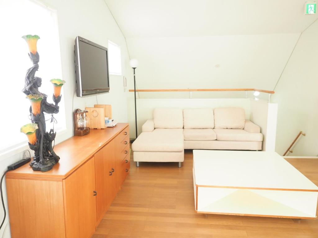 a living room with a white couch and a tv at Nasu-gun - House - Vacation STAY 7648 in Nasu
