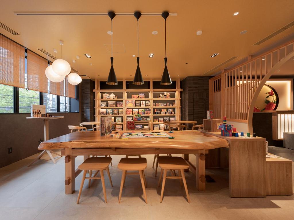 a dining room with a large wooden table and chairs at MIMARU Osaka Namba Station in Osaka