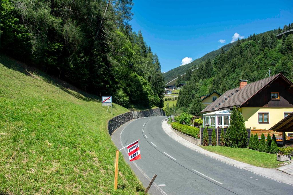 a winding road with a house on the side of a hill at Haus kremsbrücke in Kremsbrücke