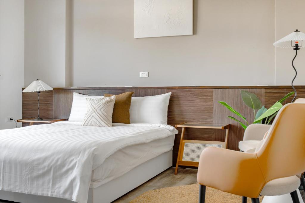 Postel nebo postele na pokoji v ubytování Yu Krung Style Inn