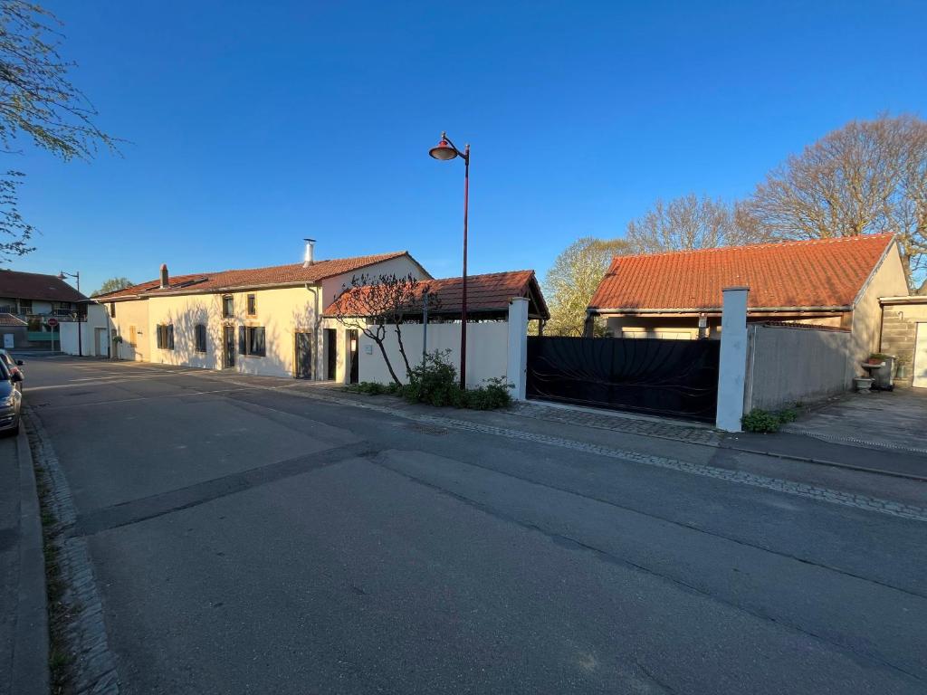 an empty street with houses and a street light at MIRABELLE in Chieulles