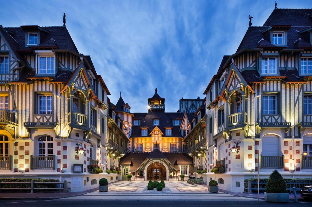 a group of large buildings with a courtyard at Hôtel Barrière Le Normandy in Deauville