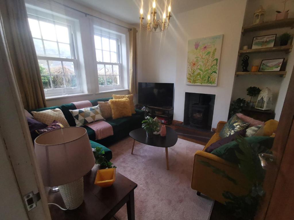 a living room with a couch and a fireplace at Prime location for Snowdon, Family and Dog friendly! in Llanberis