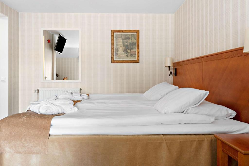 Postel nebo postele na pokoji v ubytování Best Western Strand Hotel