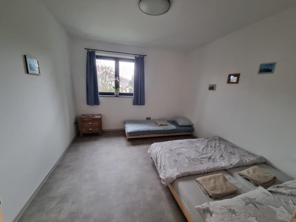 a bedroom with two beds and a window at Casa Guzinni 