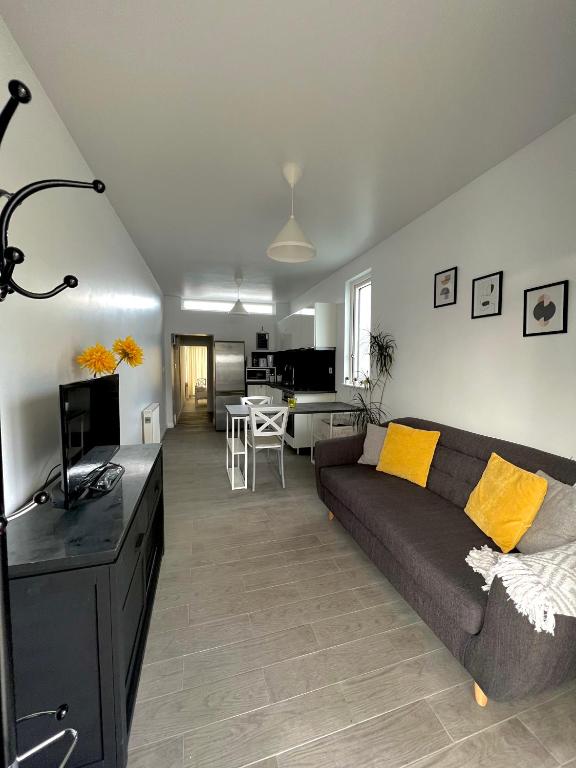 a living room with a couch and a dining room at Newly renovated 1 bedroom flat with garden pergola in Ennis