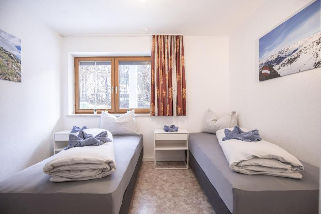 A bed or beds in a room at Sportapart Schweighofer Ski-in & Ski-out