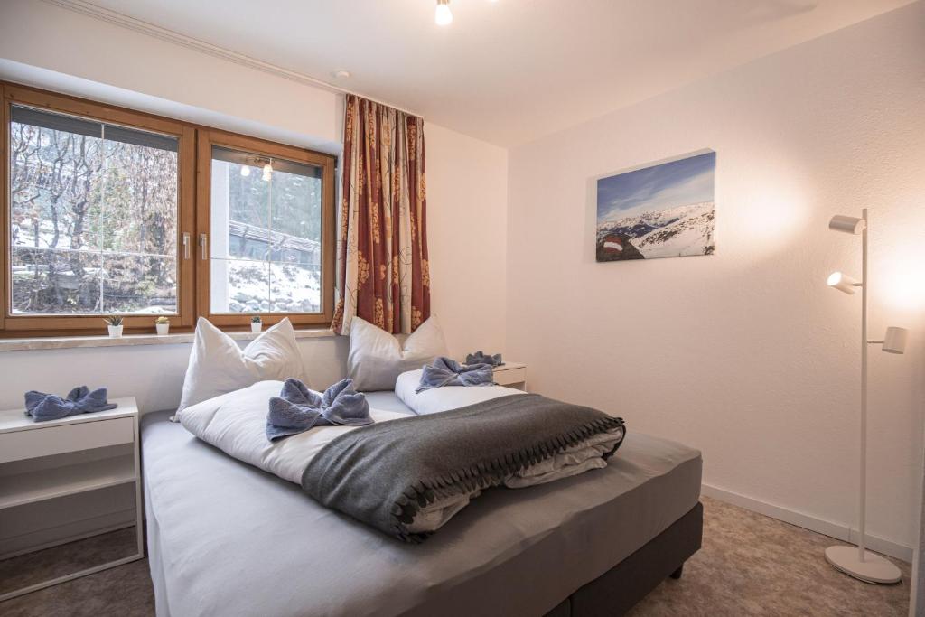 A bed or beds in a room at Sportapart Schweighofer Ski-in & Ski-out