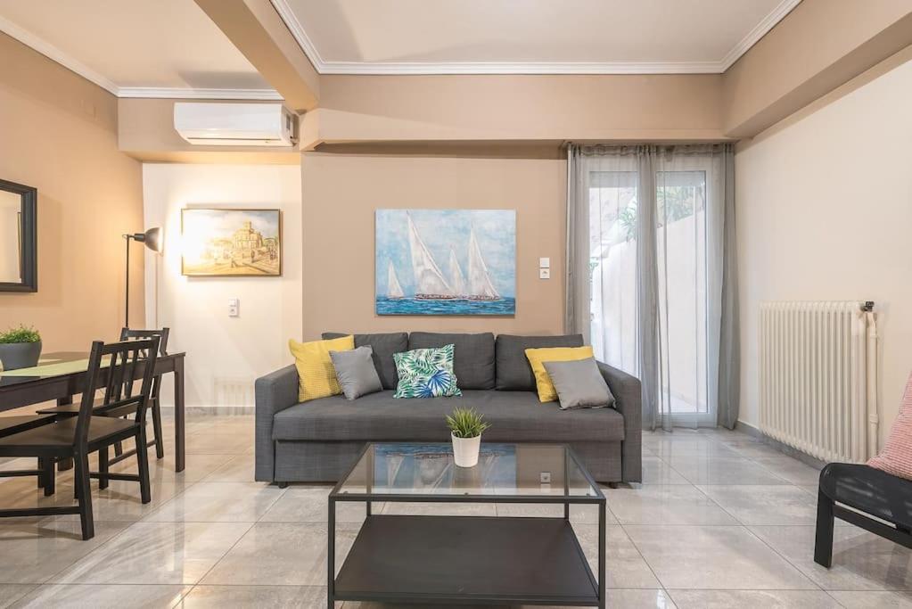a living room with a couch and a table at Pegasus Apartment in Piraeus