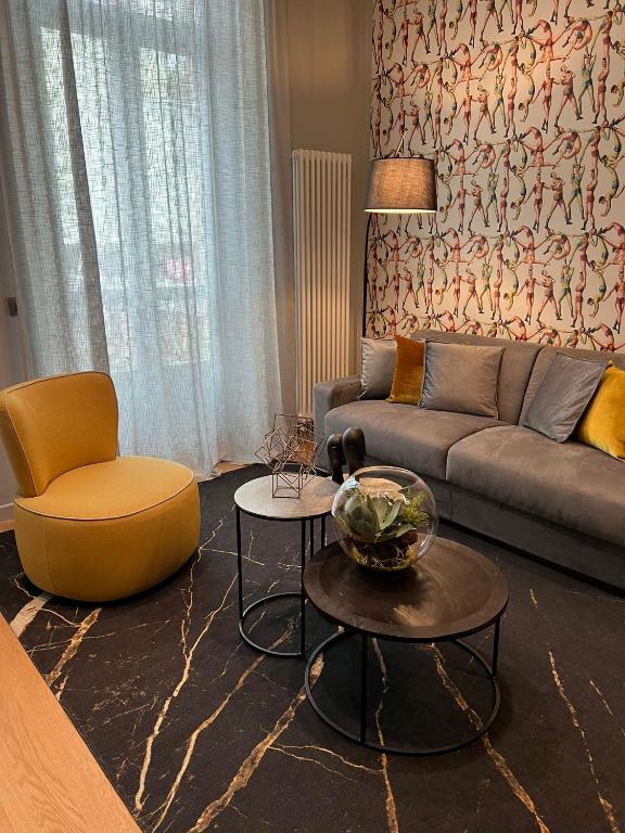 a living room with a couch and a chair at GLI EQUILIBRISTI in Cuneo