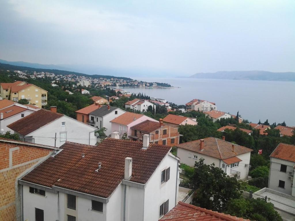 a view of a town with houses and the water at Odvojak Apartments in Crikvenica