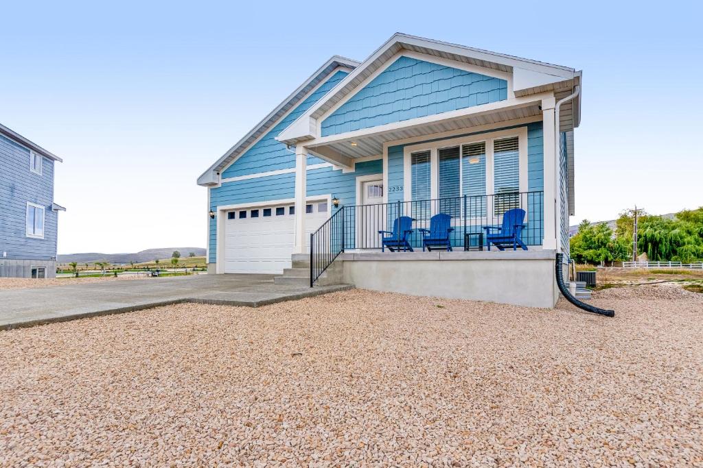 a blue house with two blue chairs on the front porch at Grandma Buddy's House in Garden City