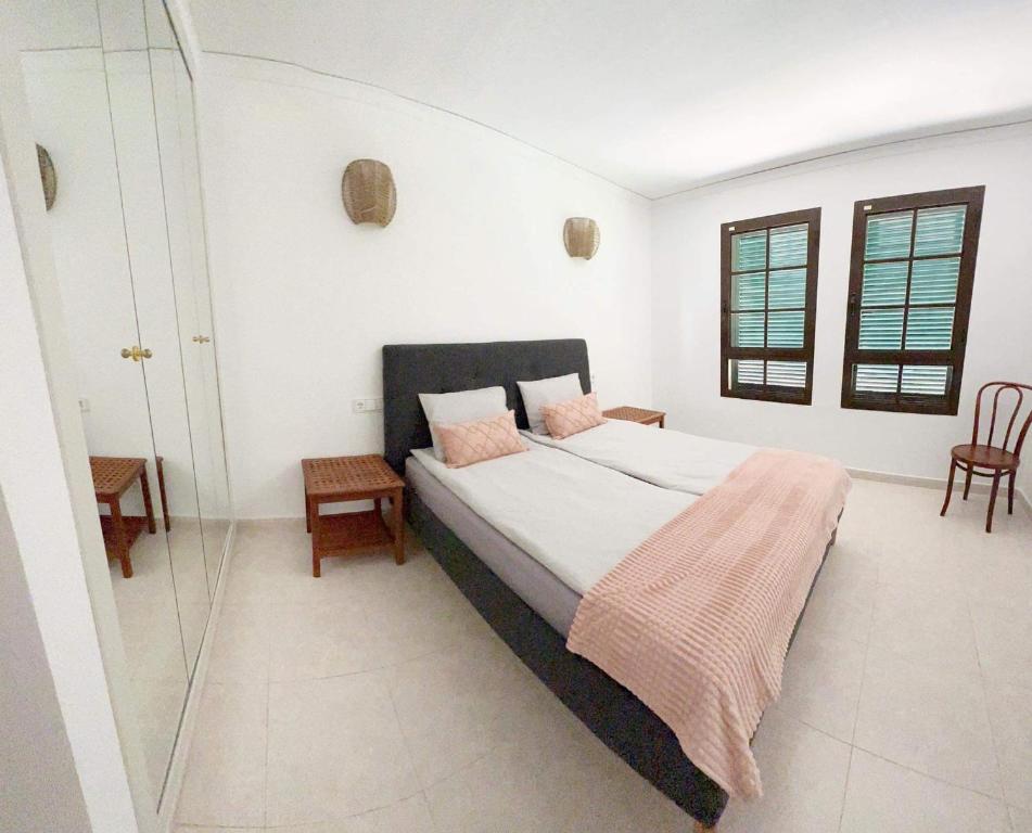 a bedroom with a bed and a glass shower at Luxury Apartments Mascarat in Altea