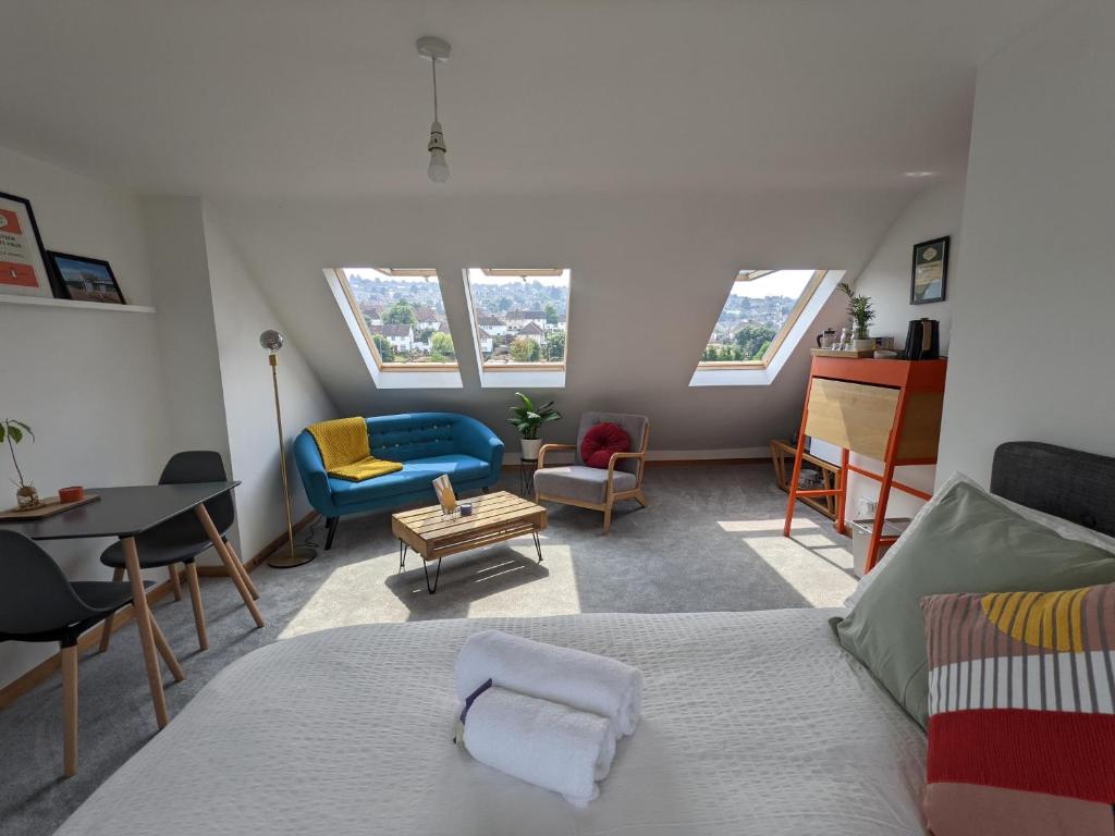 a bedroom with a bed and a living room at *Large Unique Retro Private Attic & Bathroom* in Brighton & Hove