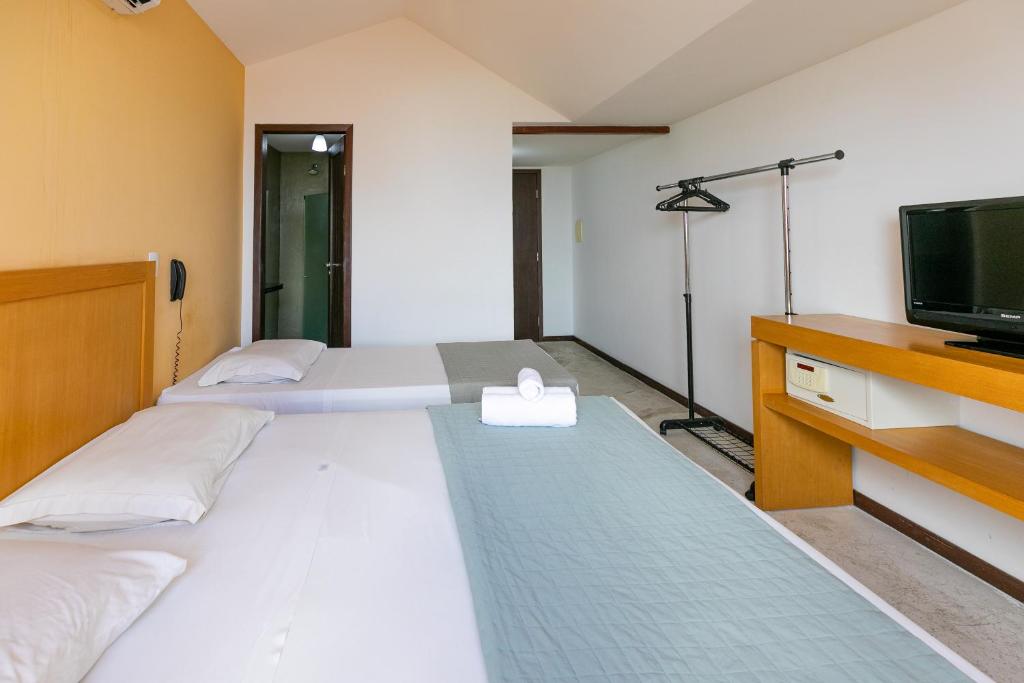 Postel nebo postele na pokoji v ubytování Safari Natal Beach Hotel