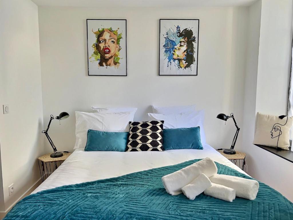 een slaapkamer met een bed met twee lampen erop bij Loc'Ouest 17 in La Rochelle