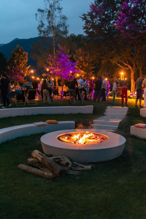 a fire pit in the middle of a park at night at Hotel Bohinj in Bohinj