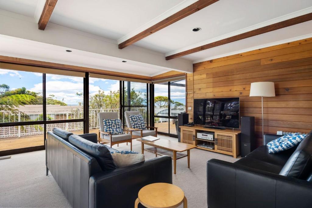 a living room with two couches and a television at Kelton Beach Haven in Mollymook