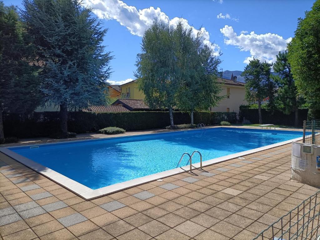 una grande piscina blu in un cortile di House in a beautiful residence with garden, swimming pool and parking spot - Larihome A07 a Domaso