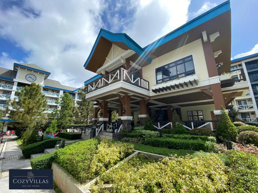 a large building with a clock on it at CozyVilla at Pine Suites Tagaytay 2BR or Studio with FREE PARKING in Tagaytay