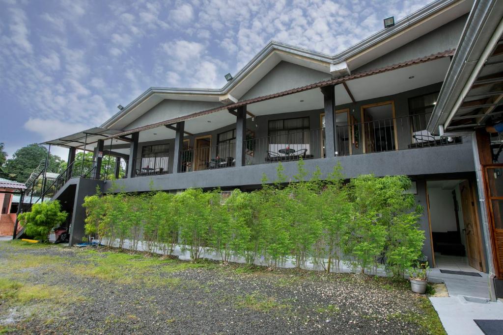 a house with a fence in front of it at Coati Arenal Lodge in Fortuna