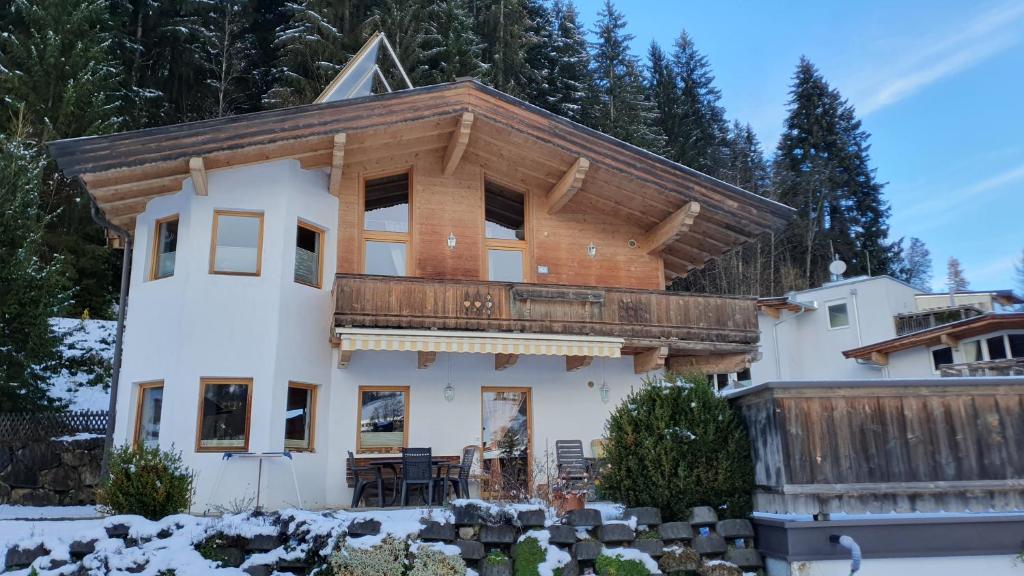 a large house with a wooden roof at Haus Carina in Kirchberg in Tirol