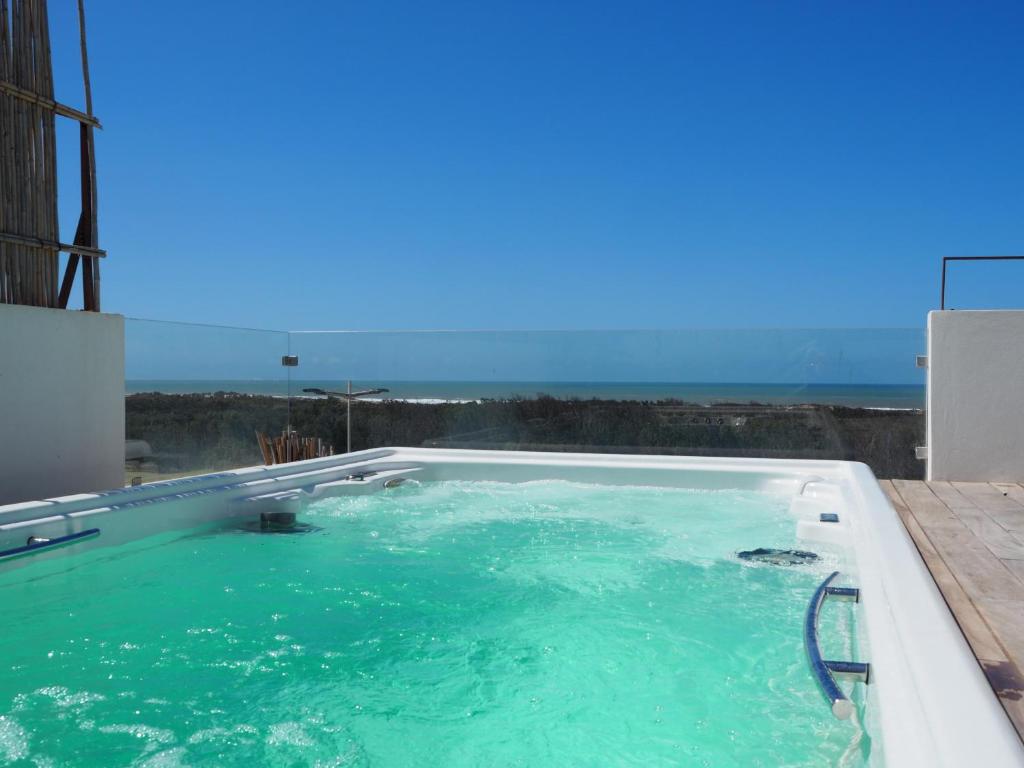 a swimming pool with a view of the ocean at Tigmi Anis in Essaouira