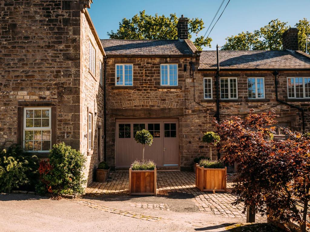a brick house with a garage and a driveway at The Gardener in Clitheroe