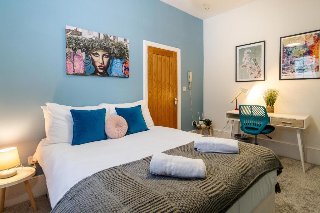 a bedroom with a large bed and a desk at Beside The Seaside - By My Getaways in Brighton & Hove