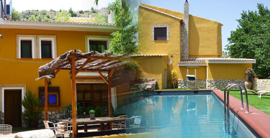 a swimming pool in front of a house at Casa el angel in Castril