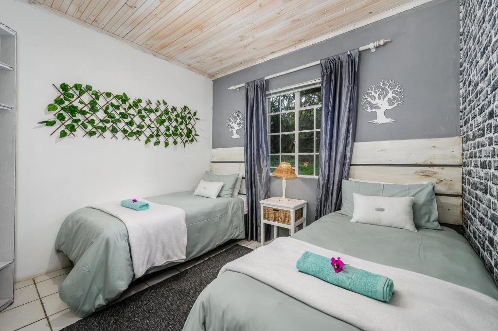a bedroom with two beds and a window at 302 On Old Sea View Road Chelsea in Port Elizabeth
