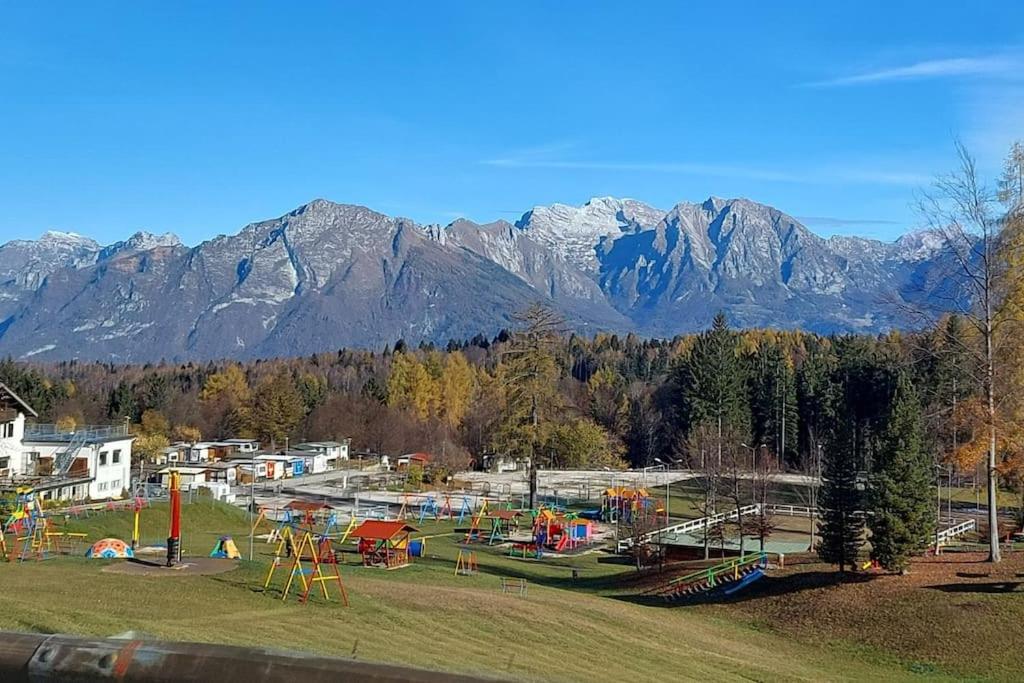 a park with a playground with mountains in the background at Il Belvedere in Nevegal