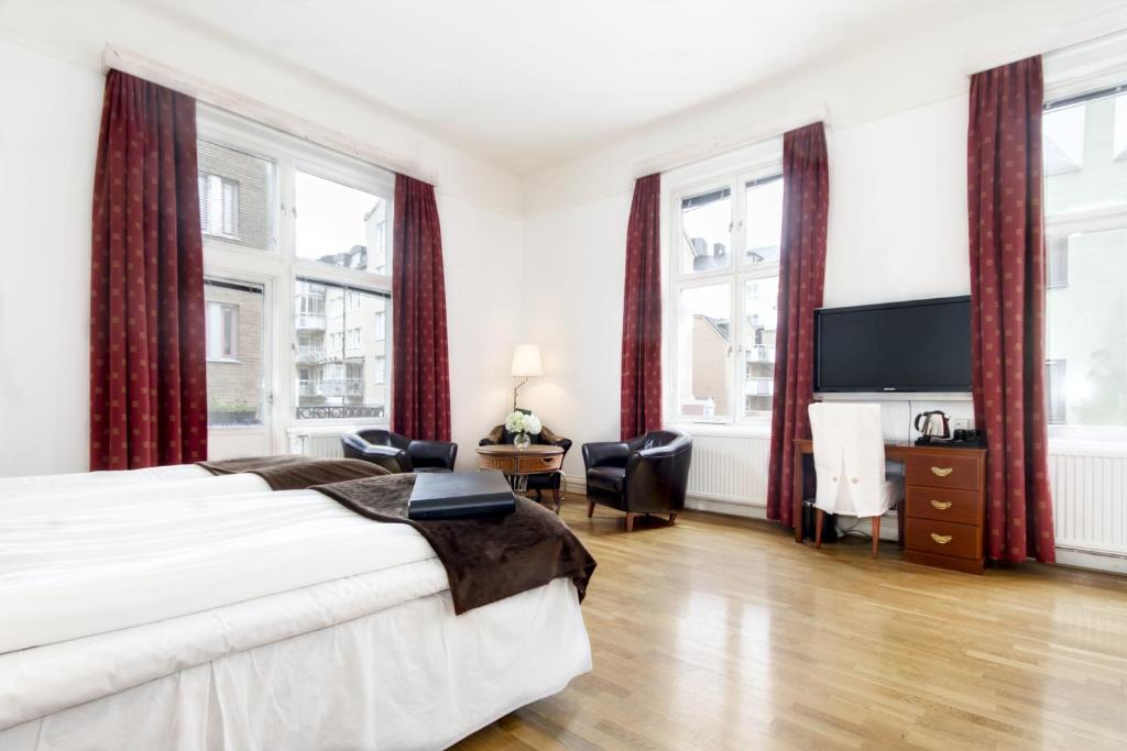 Postel nebo postele na pokoji v ubytování First Hotel Stadt