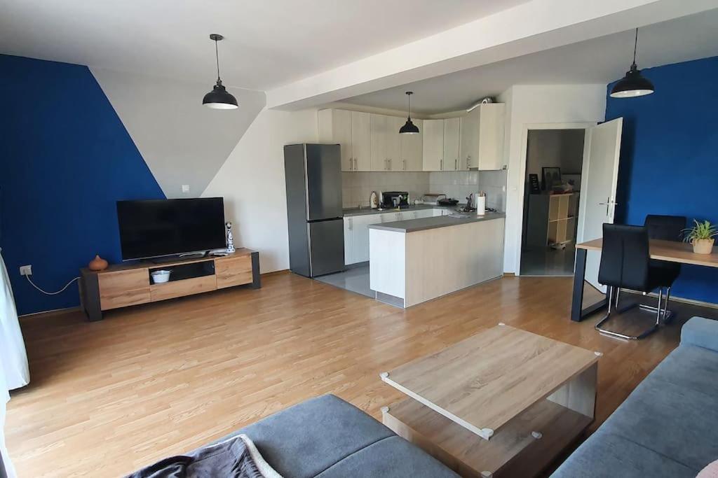 a living room with a couch and a table and a kitchen at Apartment Divine Metković72m2 in Metković