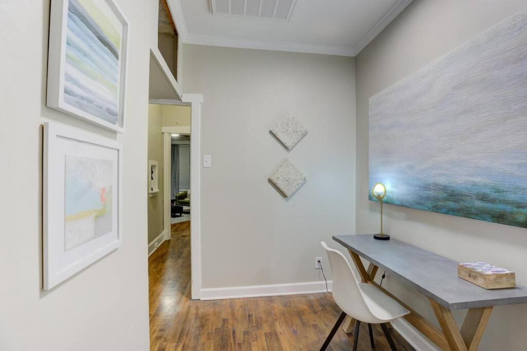 a room with a desk and a painting on the wall at Cooper Young Bungalow with All the Essentials in Memphis