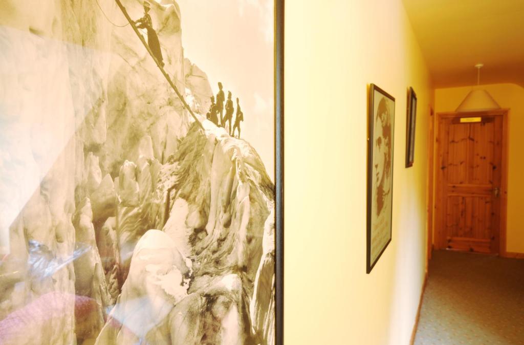 a painting on a wall in a room with a door at An Bruachan B&B in Kenmare