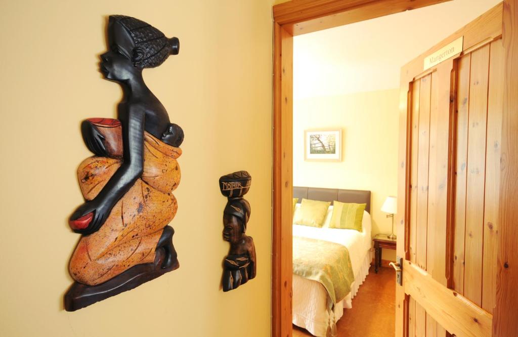 a room with a bedroom with a bed and a door at An Bruachan B&B in Kenmare