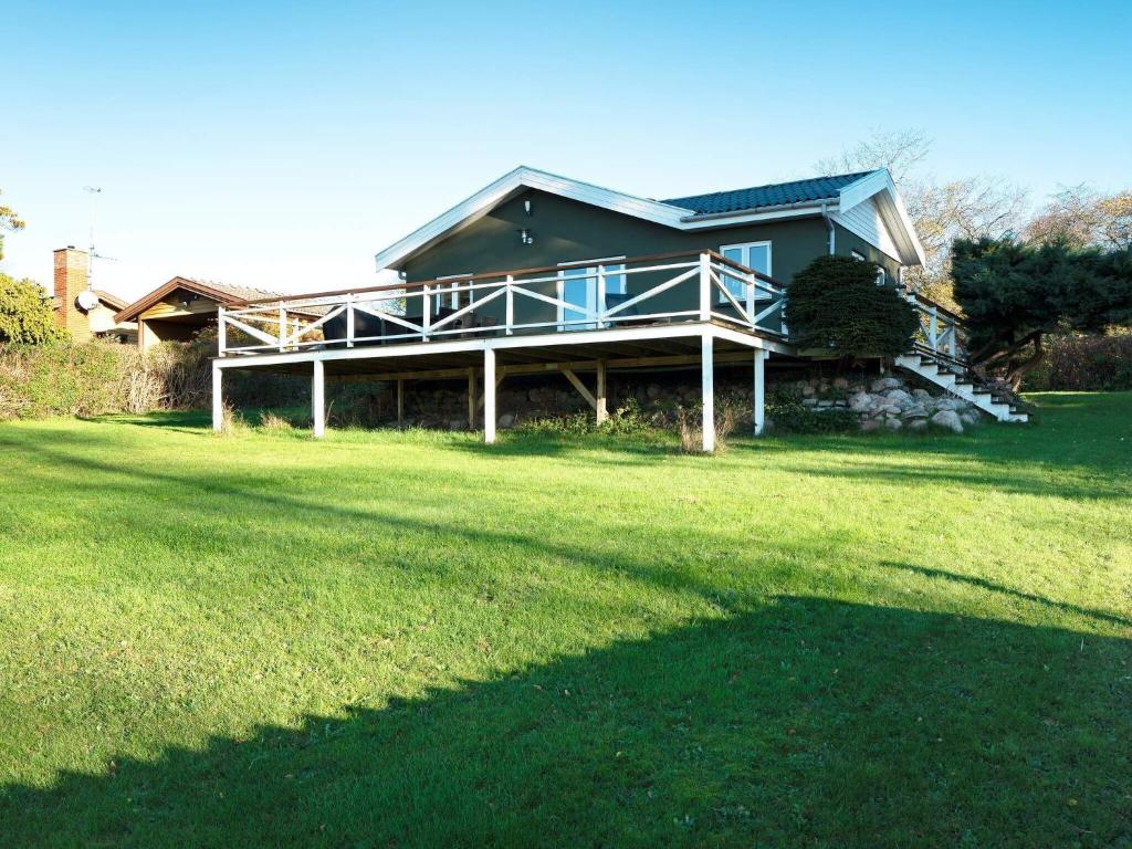 a house with a large yard with a grass field at 6 person holiday home in Skibby-By Traum in Skibby