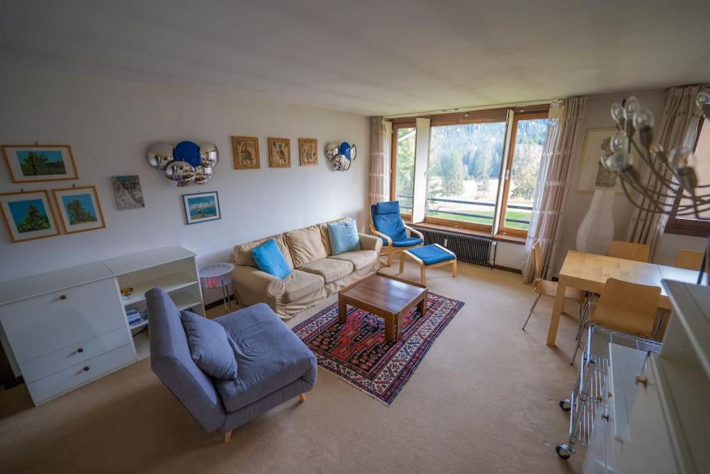 a living room with a couch and chairs and a table at Appartamento con Vista! A Due Passi dalle Piste in Madonna di Campiglio