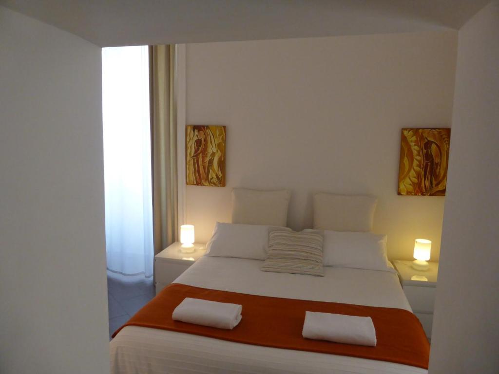a bedroom with a large bed with two pillows at iBed Napoli B&B in Naples