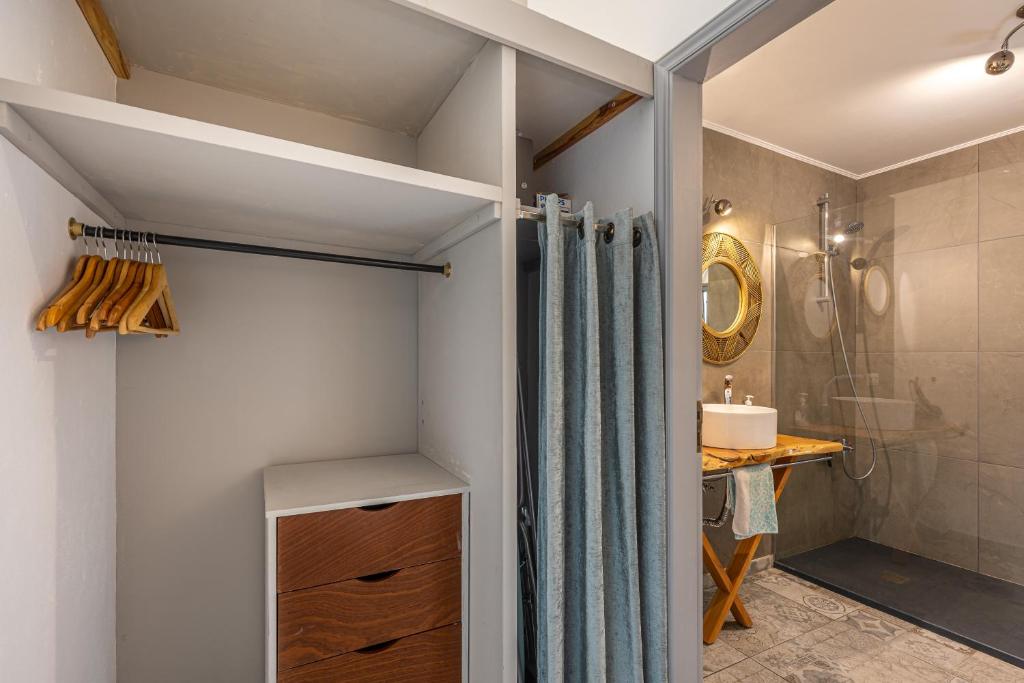 a bathroom with a shower and a shower curtain at Villa Sophia by ALMA Holiday Rentals in Caniço
