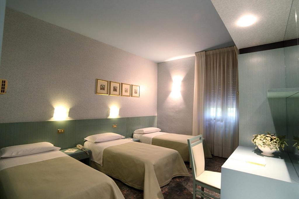 Postel nebo postele na pokoji v ubytování Hotel Globo