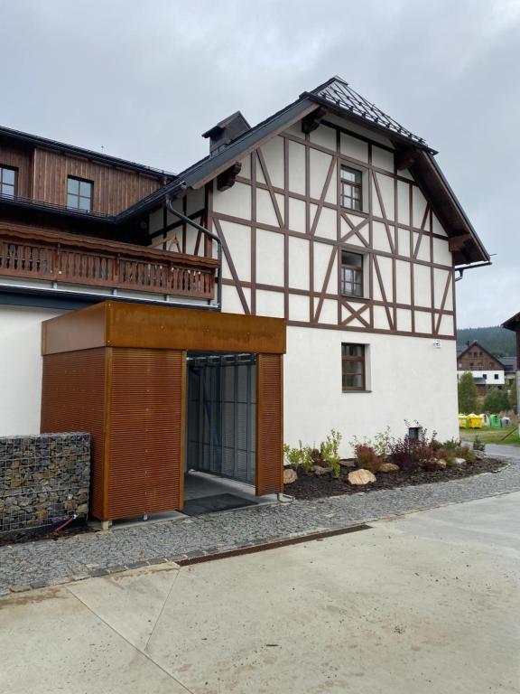 a house with a gambrel roof at Wellness apartmán Pila Kvilda in Kvilda