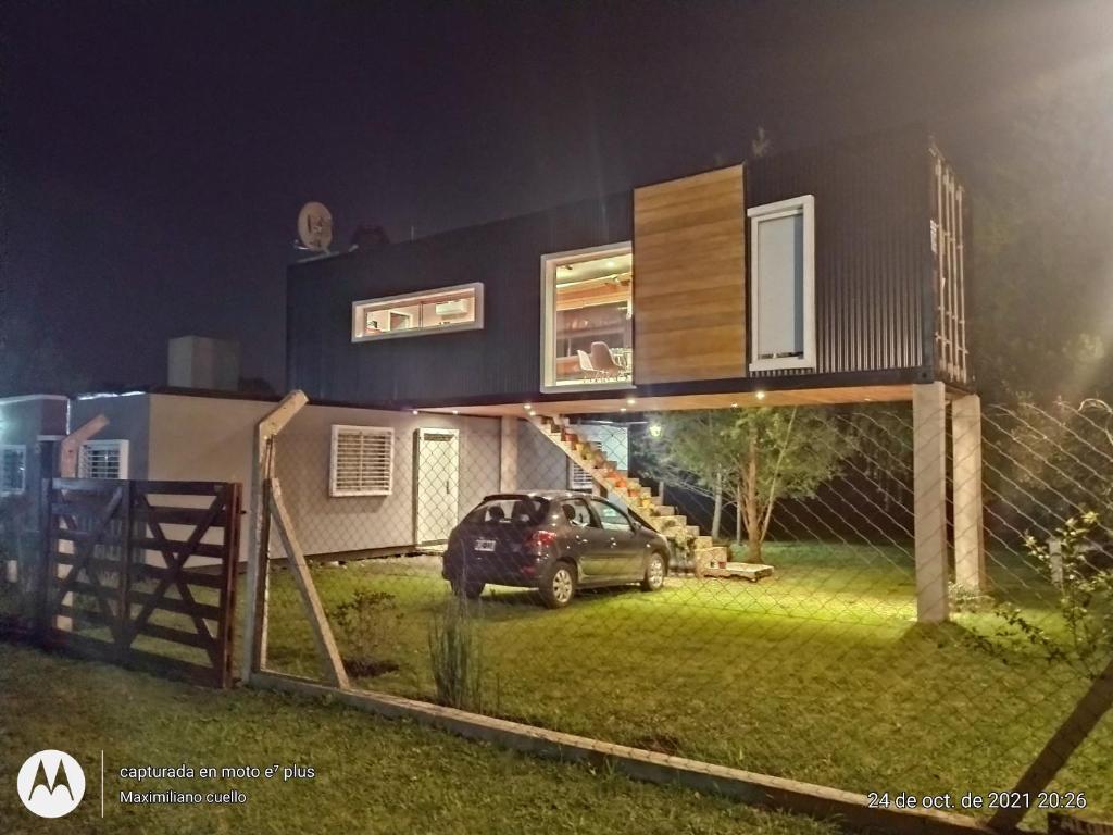 a house with a car parked in front of it at Casa container in Mar del Plata